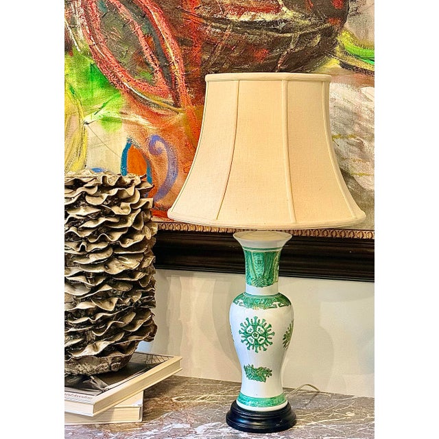 Vintage Chinoiserie Famille Verte Green and White Hand Painted Porcelain Baluster Vase Table Lamp on a Black Wood Base....
