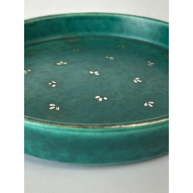 This Wilhelm Kåge Argenta ceramic bowl for Gustavsberg, produced in Sweden around the 1950s, is a distinctive Mid-Century...