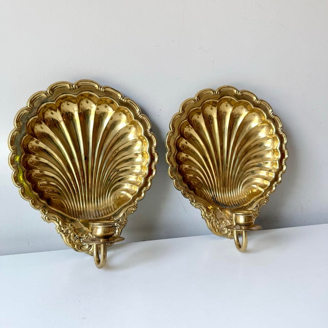 Vintage regency brass clamshell candlestick sconces with beveled trim.