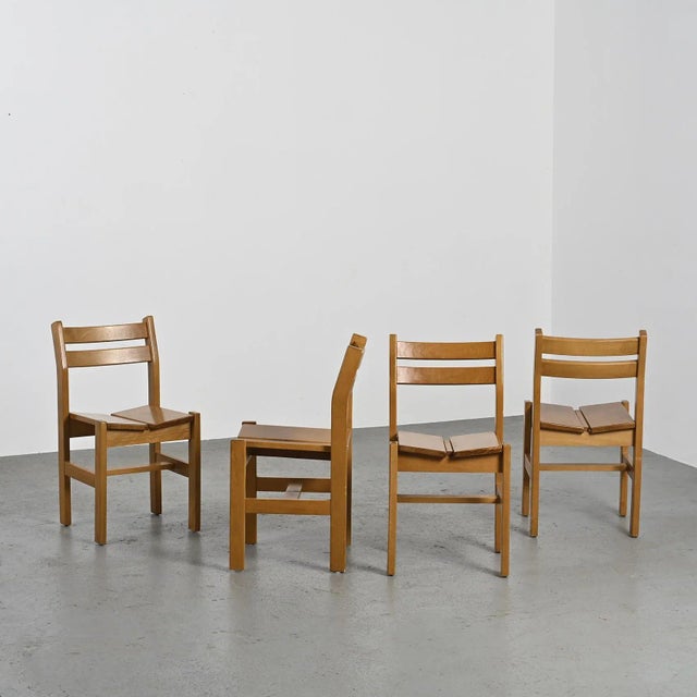 Pair of solid elm chairs selected by Charlotte PERRIAND for the Les Arcs ski resort. Seat with two cut sides and openwork...