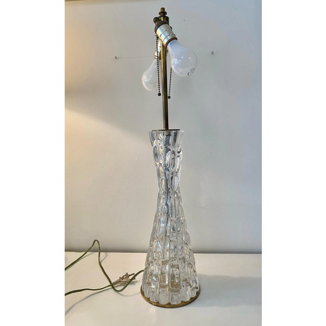 Exceptional hourglass form crystal lamp with brass fittings. The lamps were made in Sweden at Orrefors glasbruk. This is...