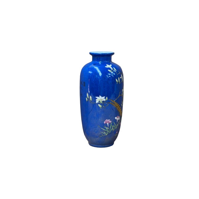 This stunning Chinese porcelain vase features a rich, vibrant cobalt blue glaze richly enameled with a vivid nature scene....