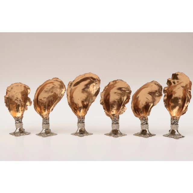 Set of six place card holders crafted from natural oyster shells with metallic gold finish on vintage Czech filigree...