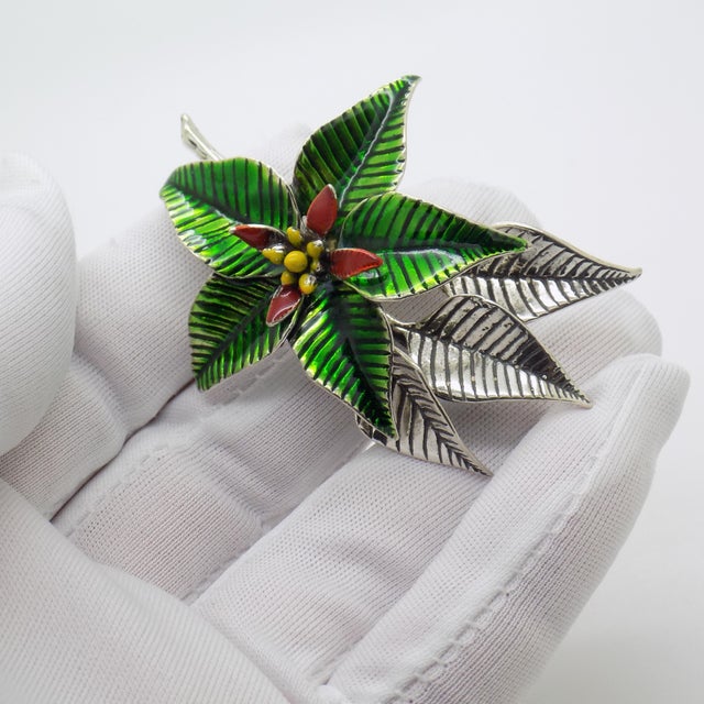 A refined poinsettia flower decoration crafted in Italy between the 1980s and 1990s, a period when Italian silver...