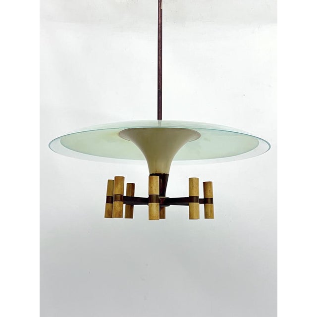 Rare disk chandelier with 8 arms in Fontana Arte manner produced in Italy during the 50s. Made from brass and laquer with...