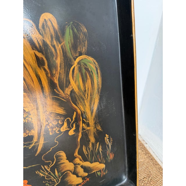 This listing is for a large mid-century vintage, hand painted metal tray. It is black with a gold rim and a vibrant...