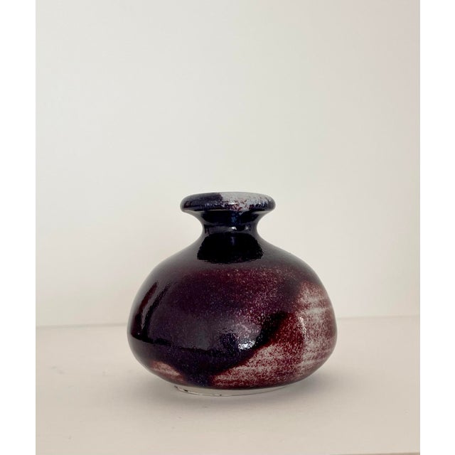 Beautiful handcrafted burgundy glazed ceramic bud vase. Artist signed.