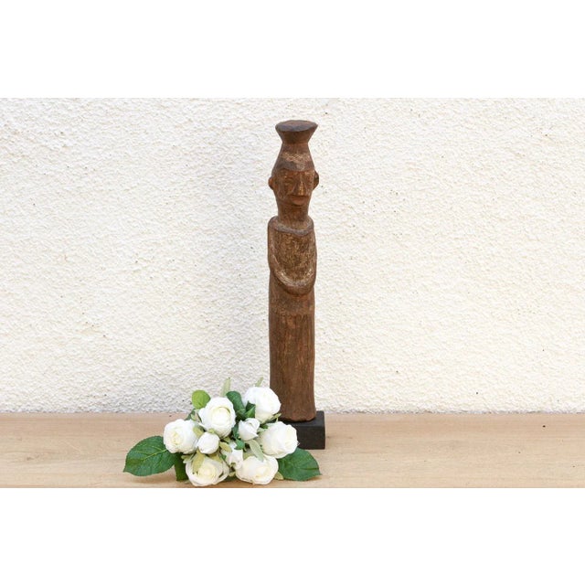 This striking figure is a powerful testament to the elegant simplicity of primitive carving. This antique tribal...