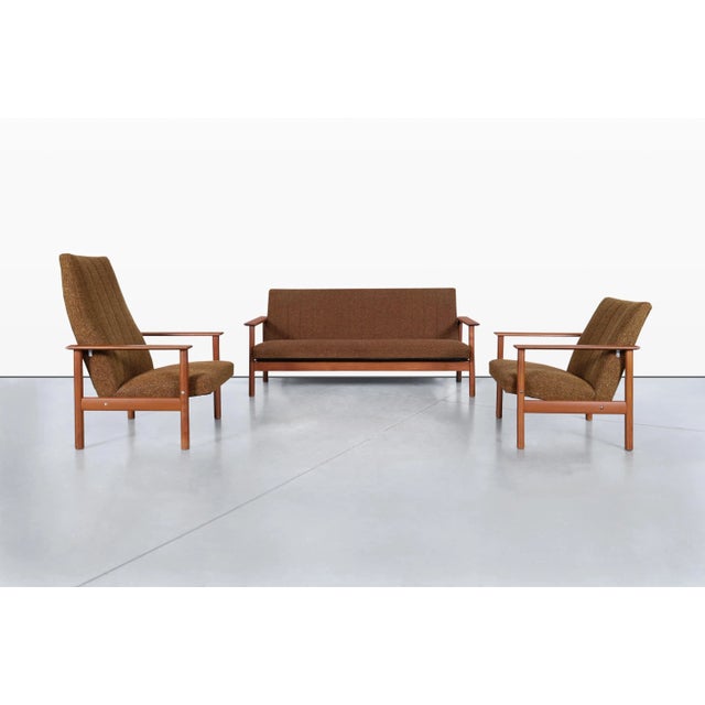 Scandinavian modern teak living room set featuring a beautifully crafted sofa and two matching lounge chairs, handcrafted...