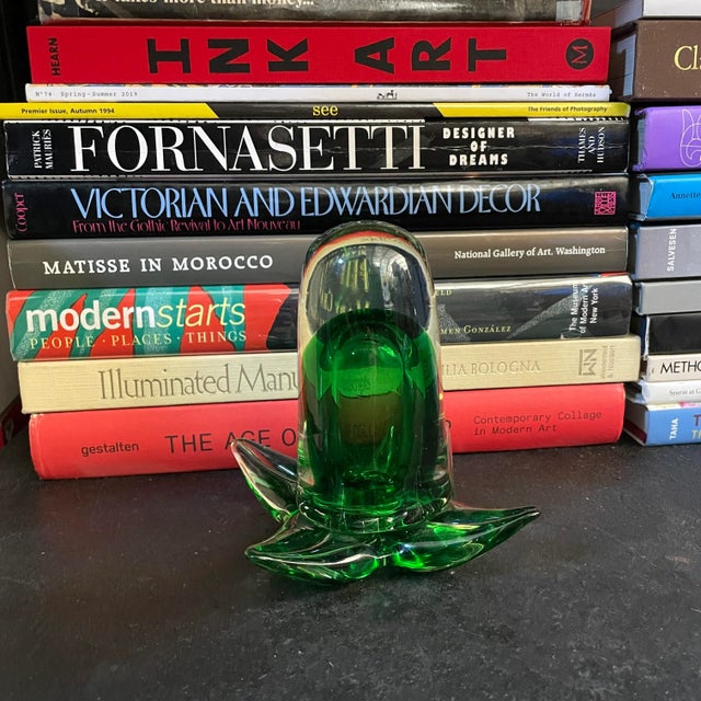 This listing is for a heavy handblown art glass sculpture paperweight in the shape of a tube flower. I'm not sure of the...