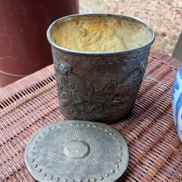 Antique European repoussé metal vessel featuring richly chased figural and foliate motifs throughout. The hand-worked...