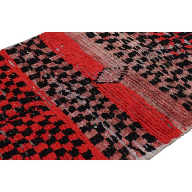 Hand-knotted in wool and originating from Morocco circa 1950-1960, this 4x9 vintage Moroccan rug is an extremely rare...