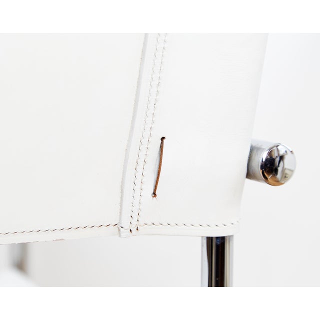 Condition: Upholstered in white full-grain leather. The leather shows moderate signs of wear. All chairs feature the...
