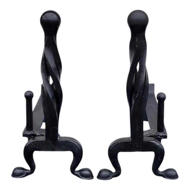 Offered here is a pair of 19th century hand-forged wrought iron andirons featuring a bold twisted column design with...