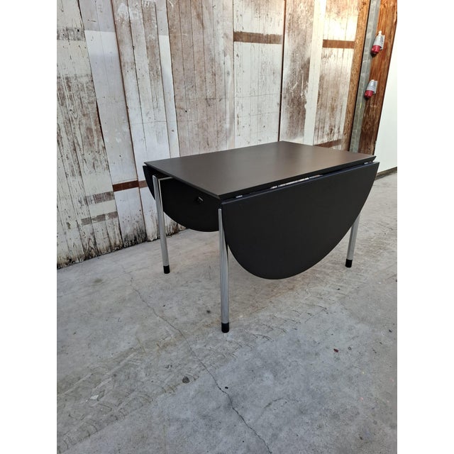 A sleek and functional Dutch design classic: the "Hangoor" table, designed by Arnold Merckx for Arco (1985). Finished in...