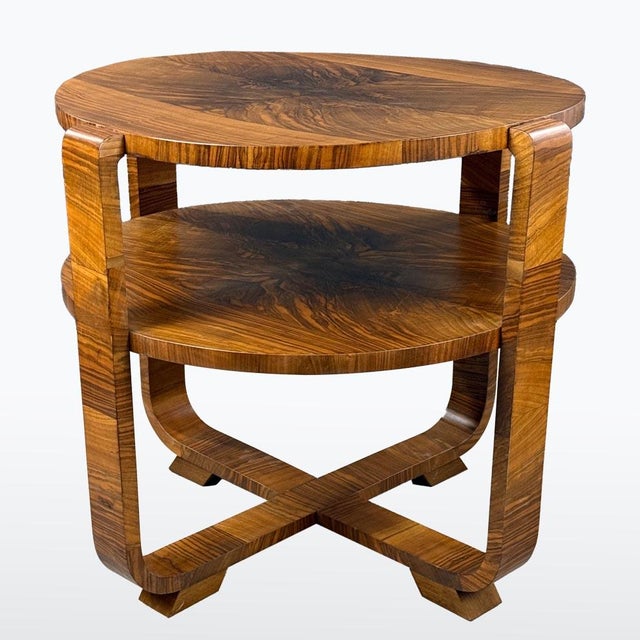 1930s Art Deco two-tier round table with striking root-wood veneer and a crossed base. Refined curves, strong grain...
