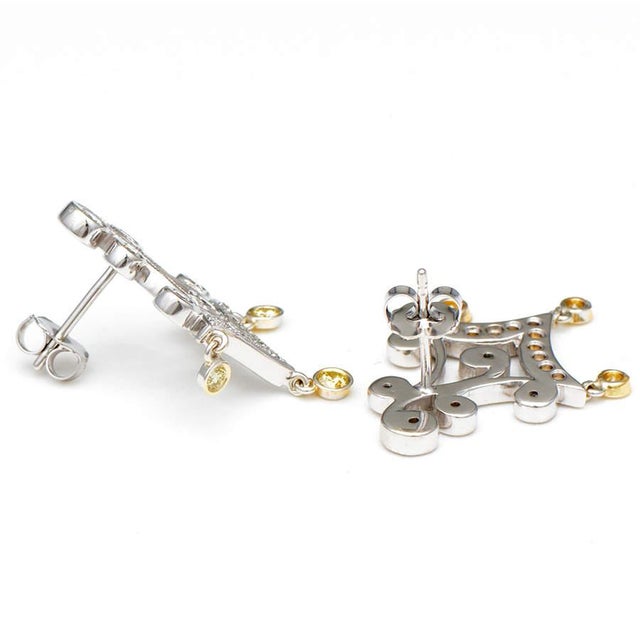 Showcasing a dramatic design combined with elegance and grace, these 14k chandelier earrings consist of white diamonds...