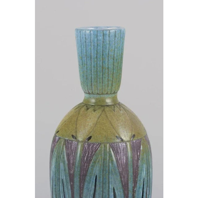 Upsala Ekeby, Sweden. Ceramic vase with polychrome glaze. Floral motifs in yellow and green. Hand-painted and hand-glazed....