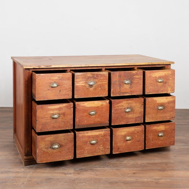 19th century Danish pine apothecary sideboard with twelve drawers. Constructed of pine with its original painted finish,...