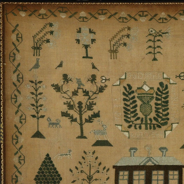 Victorian Scottish Sampler, with a house and a thistle motif. The sampler is worked in silk threads on a linen ground, in...