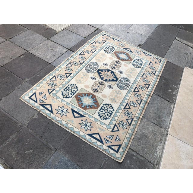 This is a vintage Turkish Oushak rug from the 1960s. The piece was hand-knotted.