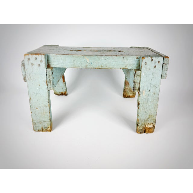 Charming early primitive wooden stool featuring its original timeworn pale blue paint and beautifully aged patina. This...