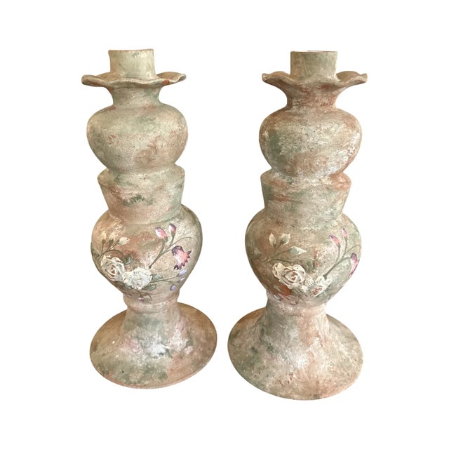 A striking monumental-scale pair of vintage terracotta candlesticks distinguished by their substantial proportions,...