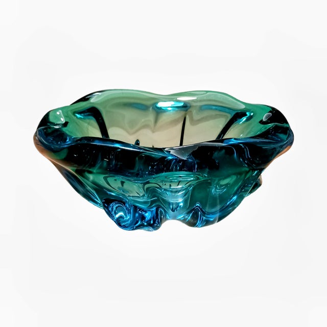 This exquisite art glass centerpiece is a true testament to the marriage of form and function, offering both visual allure...