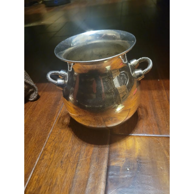 This silver plated pot features an inverted rim and rope-twist side handles, this piece can be used for chilling a small...