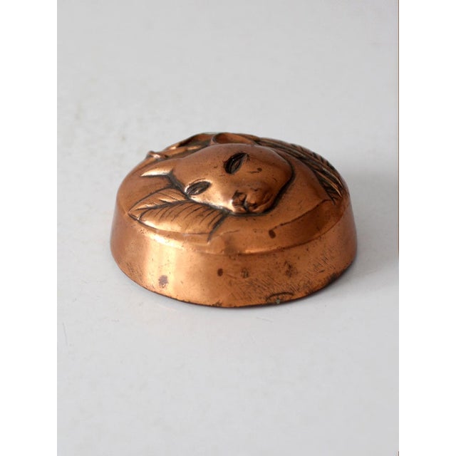 This vintage 1960s cat paperweight features a warm copper-tone finish with a beautifully detailed raised relief depicting...