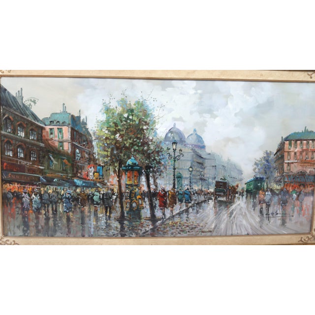 The scene depicts a crowded Parisian boulevard, likely during the Belle Époque. The characteristic domes of the city's...