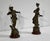 Subjects in regula with brown patina, titled "Fisherman" and "Fisherwoman", by the French sculptor Georges Maxim...
