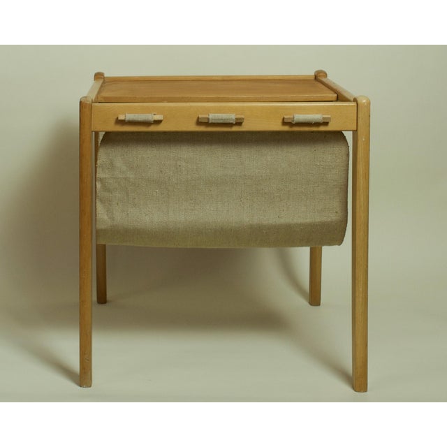 A sculptural Danish modern magazine rack by Brdr. Furbo, crafted in solid oak with an original canvas sling, circa 1970s....