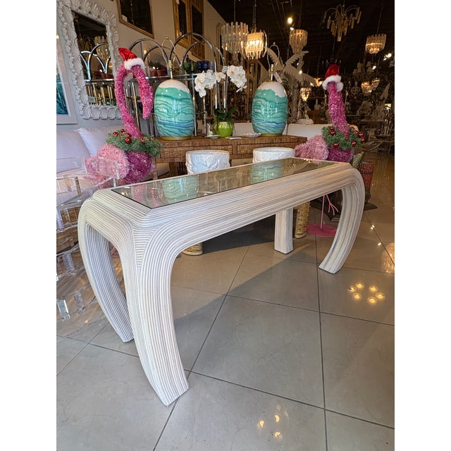 Vintage pencil reed rattan bamboo console table with ming legs. We've had a new glass top cut for this piece. No damage or...