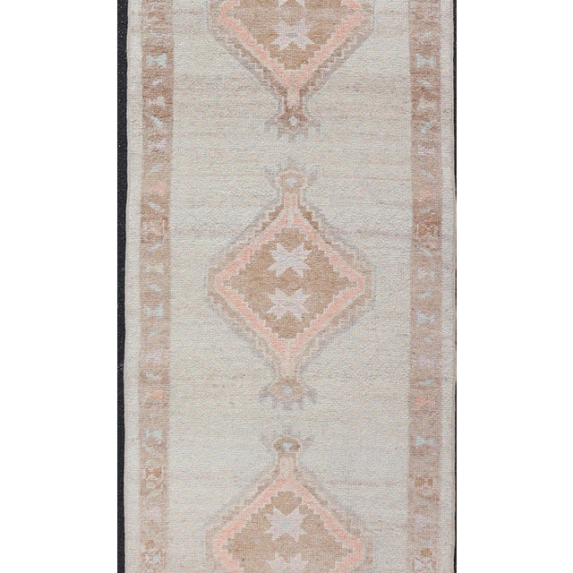 Tribal Turkish Oushak Runner With Soft Ivory Field and Peach Geometric Medallions For Sale - Image 3 of 12