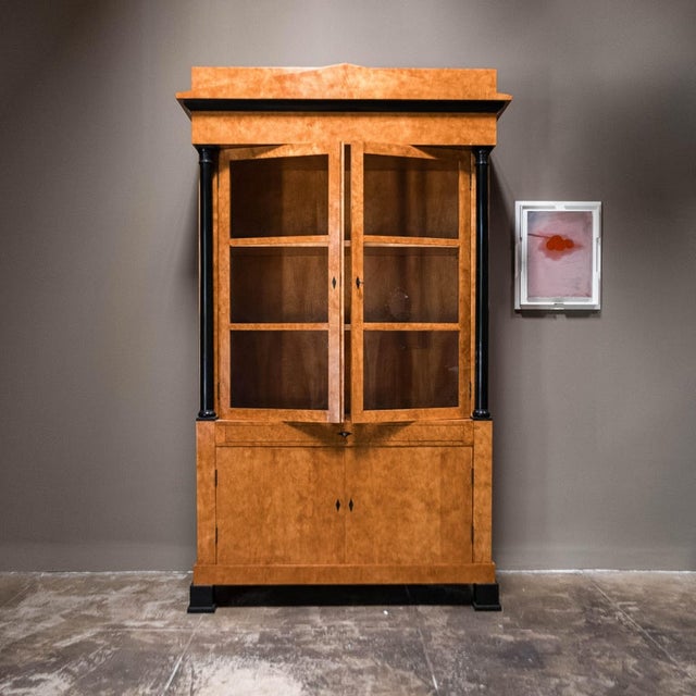 Stunning 19th Century Biedermeier style fruitwood vitrine. This exquisite piece showcases a classic Biedermeier style,...