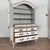 Late 18th century Swedish wedding cabinet crafted in pine. The cabinet features a white painted finish that was applied...