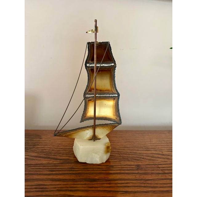 Bring timeless charm to your coastal or mid-century decor with this elegant vintage sailboat sculpture. Featuring hand-cut...