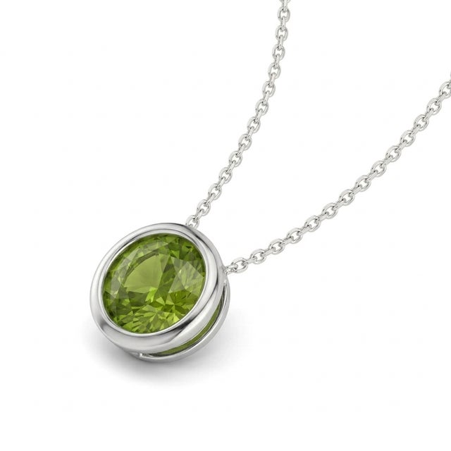 This elegant pendant features a captivating Peridot gemstone, admired for its fresh lime-green hue and natural brilliance....