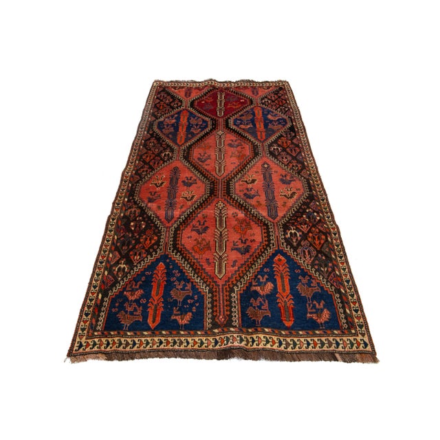 This exquisite vintage Persian Shiraz features a stunning terracotta base, beautifully complemented by intricate blue and...