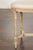 A French Neoclassical style walnut bench from circa 1900 with carved décor, fluted carved legs on arrow feet and cross...