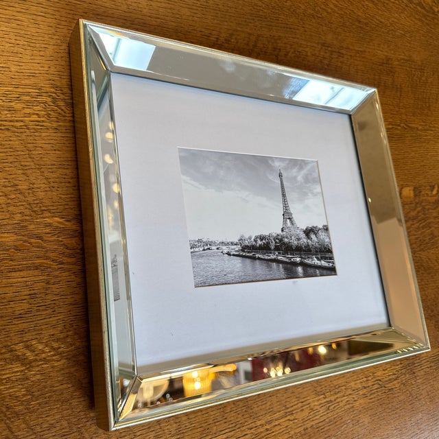 Design Plus Gallery presents an Eiffel Tower Photograph in a Beveled Mirror Frame. The photo is in black and white with...