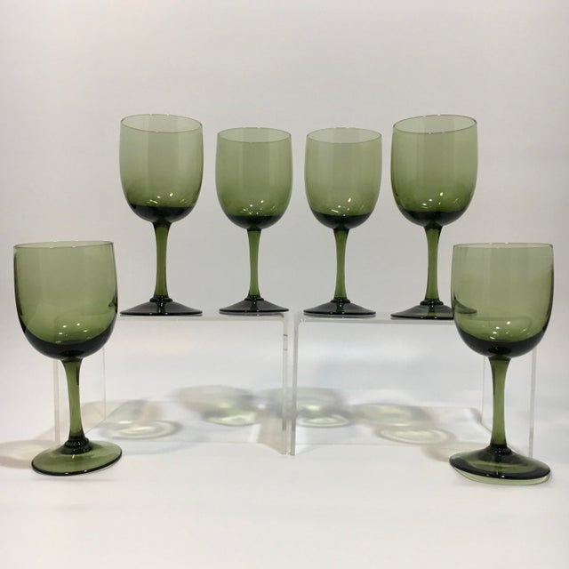 This set of six bottle green colored cordials glasses are hand blown and most likely date to the 1970s. Dimensions: 2.25”...