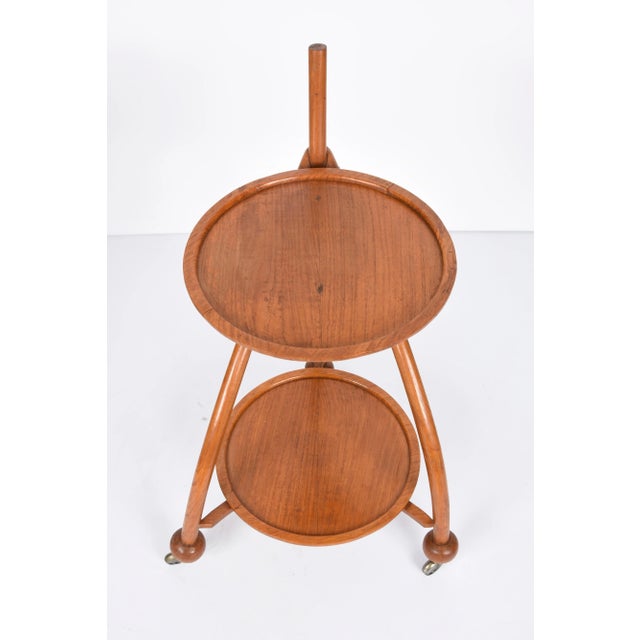 Amazing art deco two-level solid fruitwood tripod trolley bar cart. This fabulous item was designed in Italy during the...