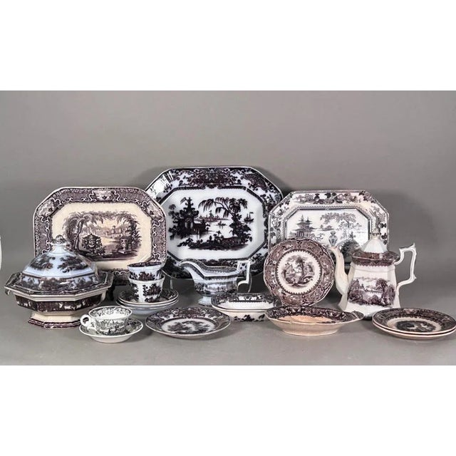 An assembled collection of 19th century English black transferware ironstone, featuring mostly Pagoda pattern pieces with...