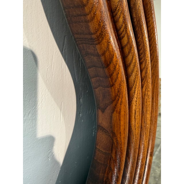 A striking Mid-Century Modern floor mirror featuring a sculptural, undulating wave-form oak frame. The organic curves of...