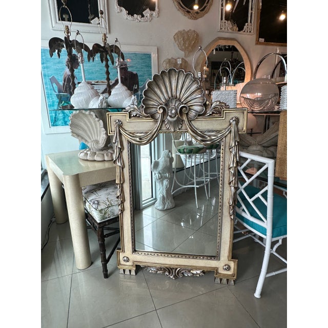 Vintage silver and gold draped shell wall mirror. Original silver & gold finish. Comes ready to hang. Dimensions: 55.5 H x...