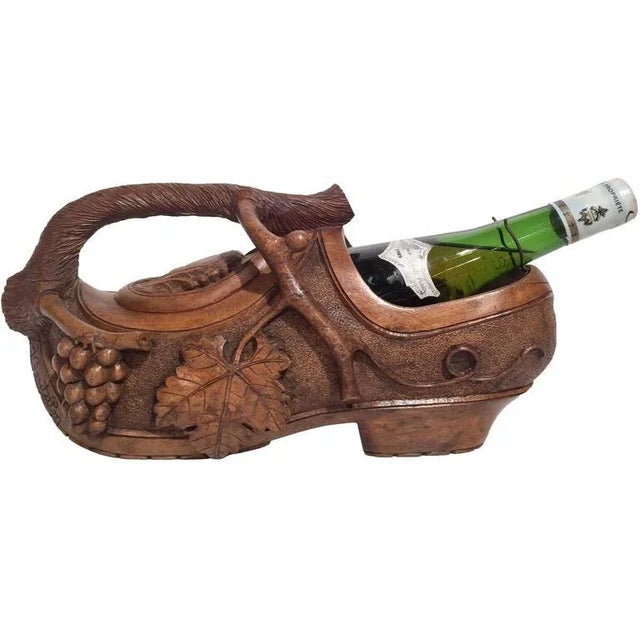 Serve wine with rustic charm using this antique French carved walnut bottle holder, sculpted circa 1920 in the form of a...