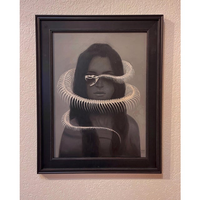 In "Solitude," a solitary figure emerges from a muted background, with long, flowing hair framing a face marked by a...
