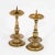 Two brass candlesticks with balustraded shafts and drip trays with spikes. The candlesticks are not identical in their...